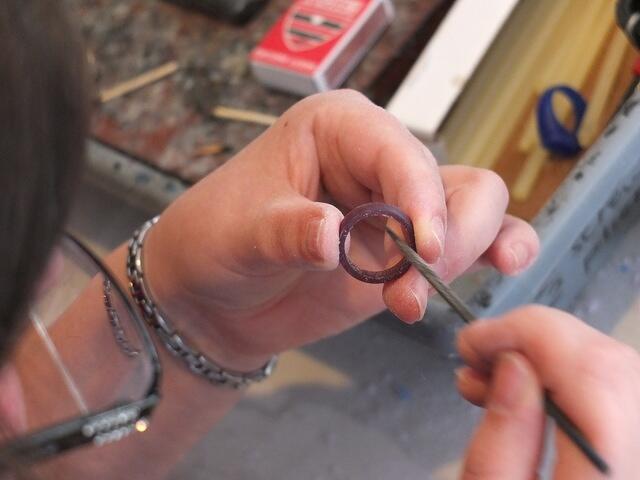 Eleanor smoothing the inside of her ring with a file